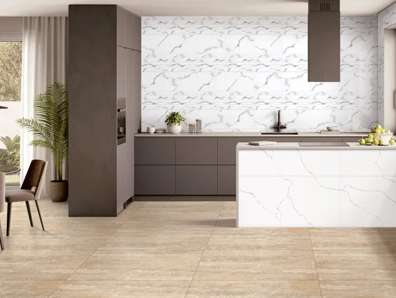 Modern white island kitchen design featuring white marble-effect wall tiles.